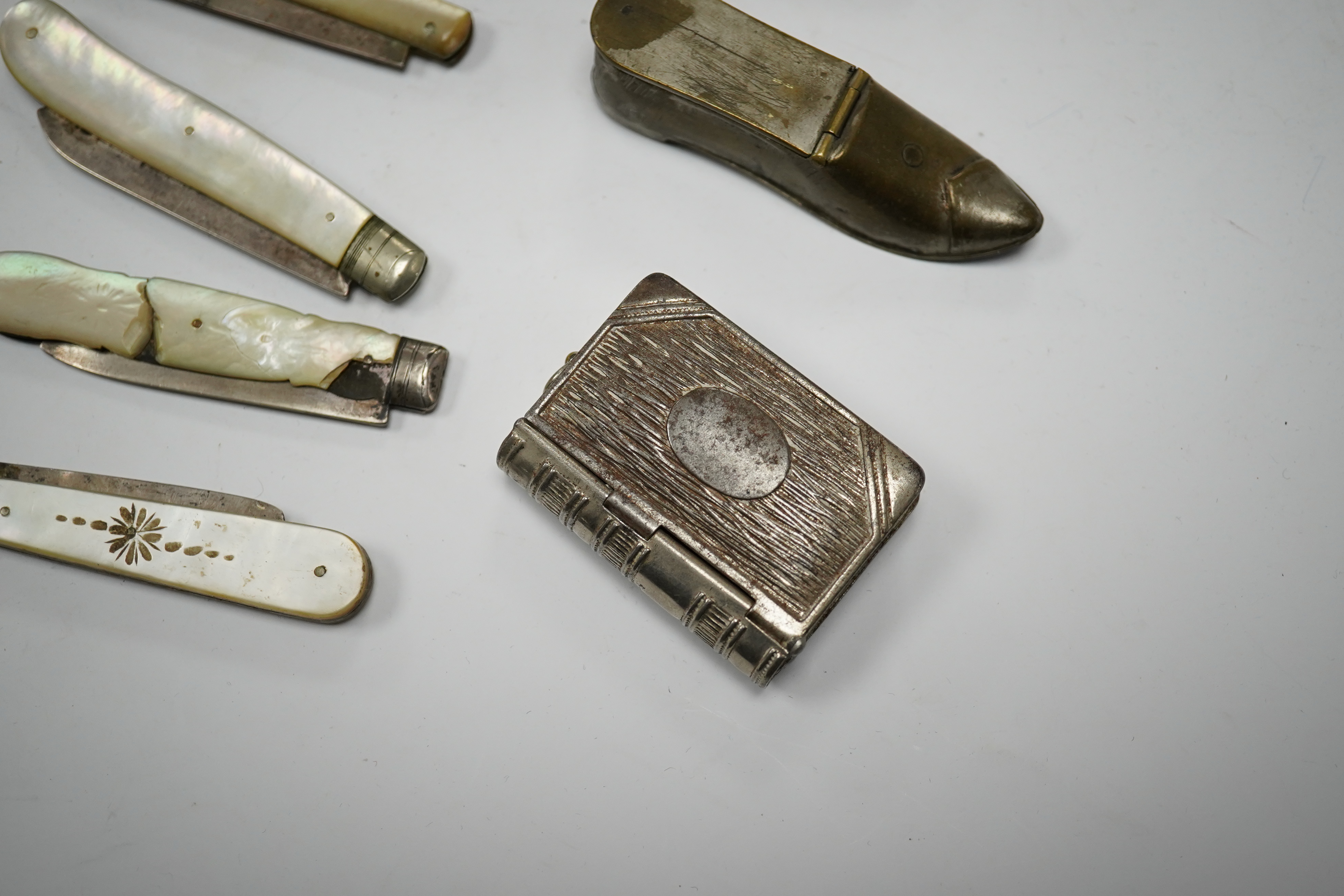 Four mother-of-pearl penknives, two vesta cases and a treen shoe, treen shoe 10cm long. Condition - fair